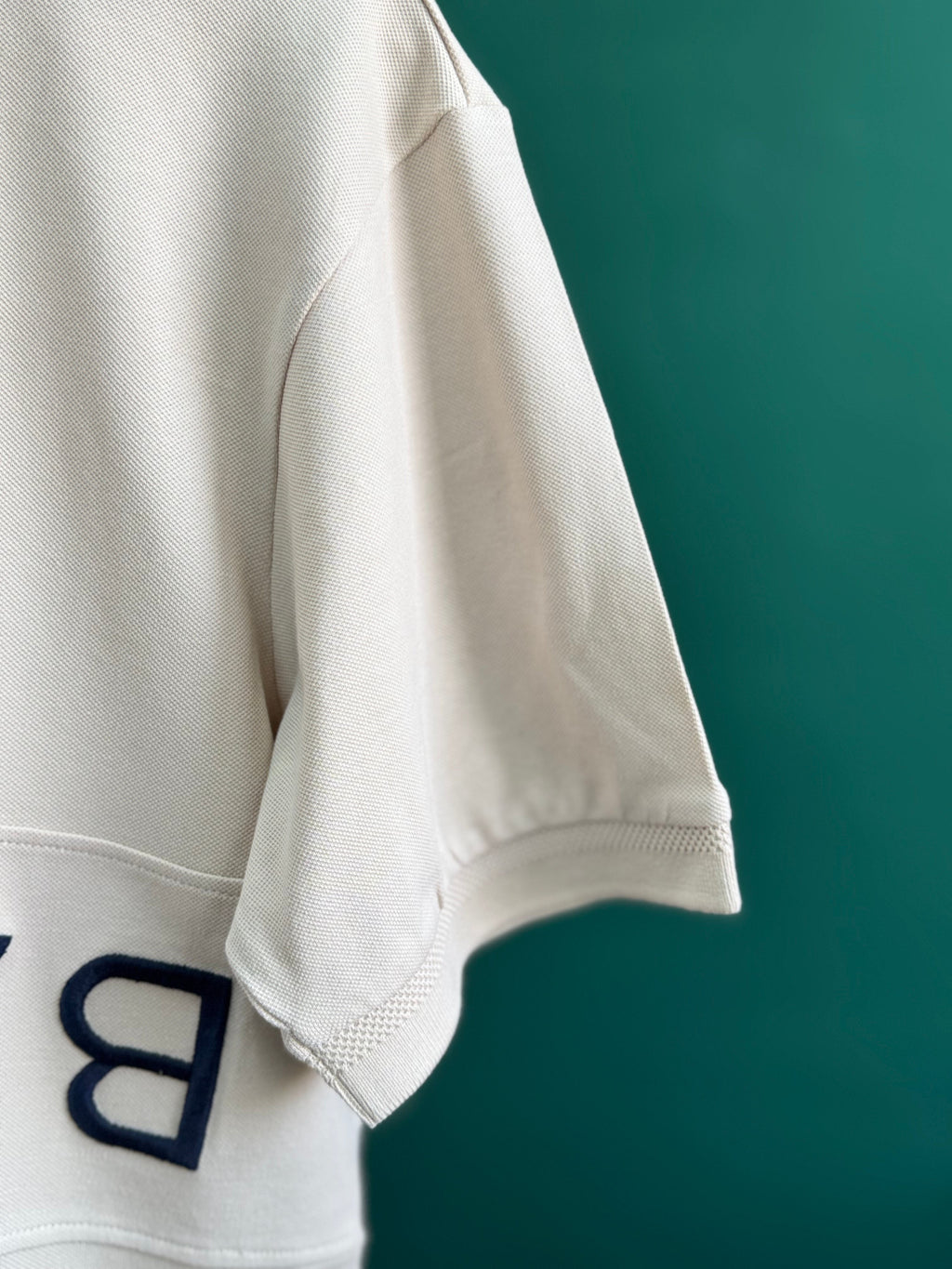 BALMAIN TEXT REVERSE EMBROIDERY POLO SHIRT | CREAM